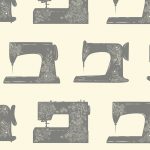 gray sewing machine in a beige background fabric